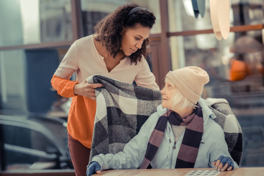 Elderly and caregiver in winter